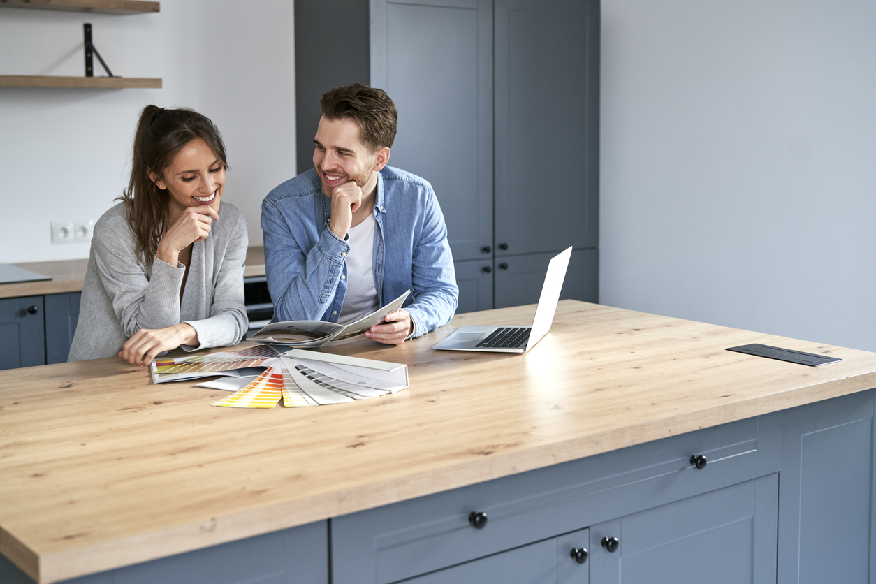 Caucasian couple choosing colors for new house
